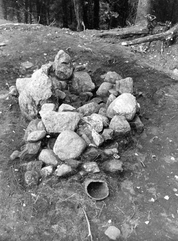 Akmeņu krāsns paliekas Obzerkalna pilskalnā, priekšplānā pie krāsns – māla pods. 1974. gads.