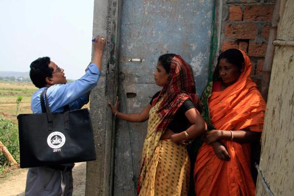 Tautas skaitītājs iezīmē māju pēc ciemata iedzīvotāju aptaujas. Indija, 2010. gads.