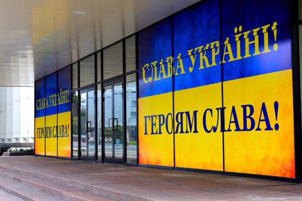 Uzraksts ukraiņu valodā "Slava Ukrainai! Varoņiem slava!" Ukrainas karoga krāsās pie Dņepropetrovskas apgabala pārvaldes ēkas. Ukraina, 2020. gads.