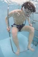 Sportistam tiek veikta zemūdens hidrostatiskā ķermeņa tauku svēršana vingrojumu fizioloģijas laboratorijā De Ansas koledžā (De Anza College). Kupertino, Kalifornijā (ASV), 2010. gads.